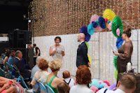 a wedding ceremony in a room with colorful decorations
