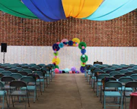a colorful wedding ceremony set up in a large room