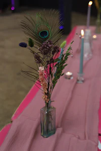 a pink tablecloth with a vase of flowers