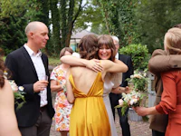 a bride hugging her bridesmaids at a wedding
