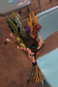 a bouquet of flowers is sitting on a blue chair