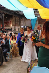 a rainbow wedding ceremony in a warehouse