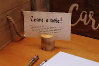 a note card sitting on top of a wooden table