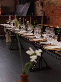 a long table with a vase of flowers